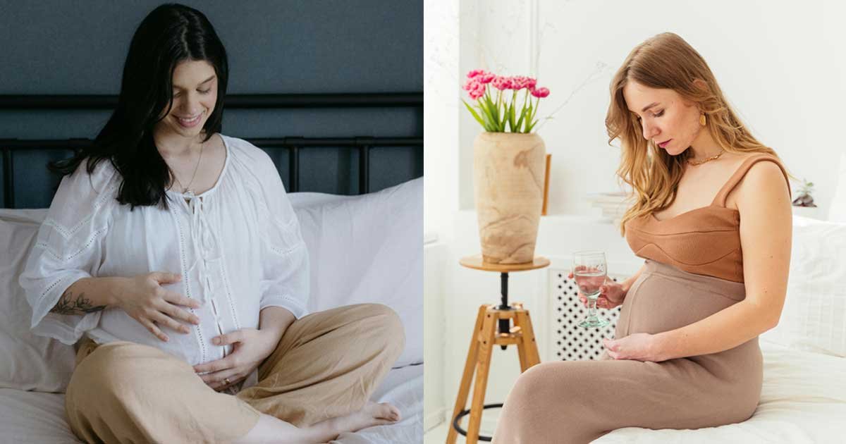 Pregnant woman sitting on a bed touching her baby bump in a calm indoor maternity photoshoot pose
