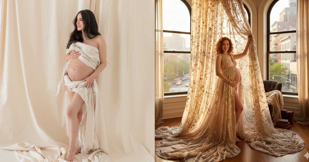 Pregnant woman posing in an elegant maternity dress near a window in a softly lit indoor setting
