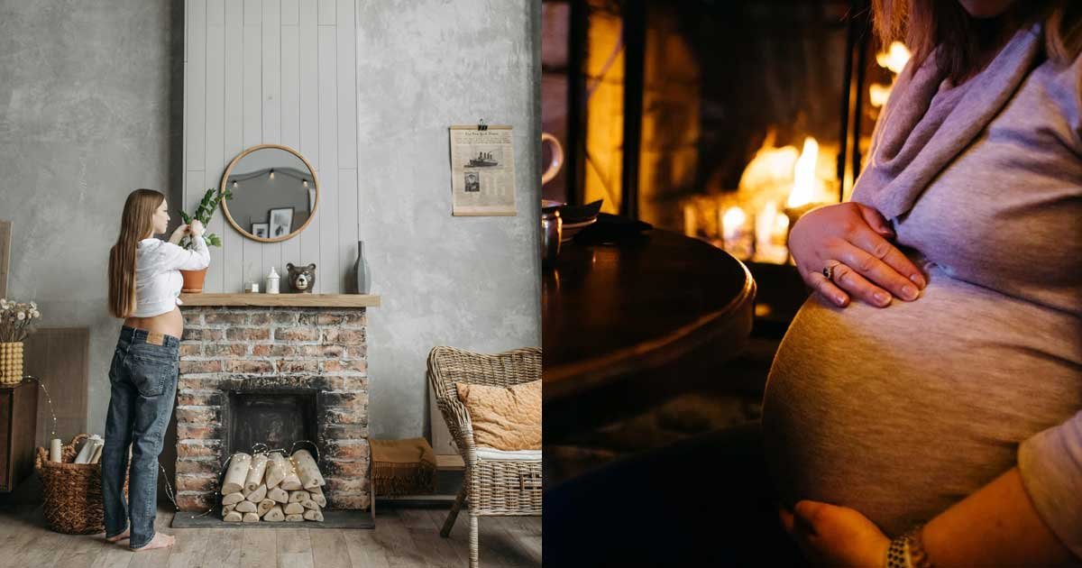 Pregnant woman at home, gently holding her baby bump near a fireplace in a cozy setting