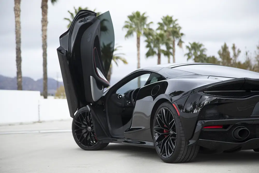 black-mclaren-supercar-raw-sample-photo Black McLaren supercar with butterfly door open, RAW sample photo
